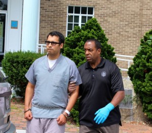 CCB MEDIA PHOTO Adrian Loya is led into a vehicle to be returned to Bridgewater State Hospital after his arraignment.