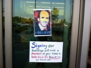 Signs on entrance door of the Market Basket in Sagamore show CEO Arthur T. Demoulas.
