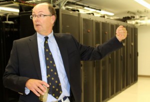 CCB MEDIA FILE PHOTO Dan Gallagher, former co-founder of Open Cape, shows off the service racks that Open Cape rents out to municipalities and other entities on the Cape. Speed and reliability are two main benefits provided by the Open Cape broadband network, he said.