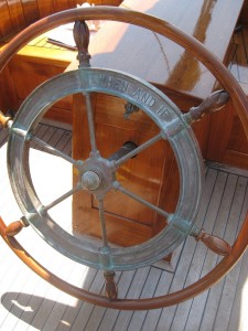 The steering wheel includes the name of the ship.