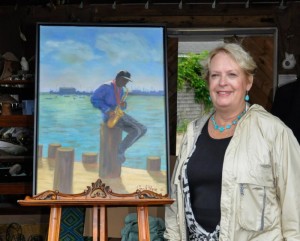 Artist Jo Ann Ritter with her work "He Played Until the Sun Went Down", the commemorative painting for the 26th Annual Cape Cod Five Pops in the Park.  Photo credit: Maddie McNamara