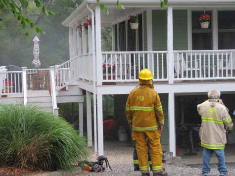 Firefighters look on as smoke is ventilated after an electrical panel caught fire in Provincetown