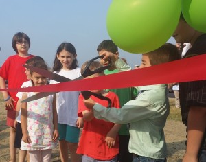 CCB MEDIA PHOTO Kids take part in the ribbon cutting of the new playground area at Veterans Park Beach