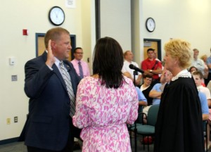 CCB MEDIA PHOTO Rodney Collins is sworn in as Mashpee Town Manager by Mashpee Town Clerk Deborah Dami, as right. Collins' partner Kate Sampson is with her back to the camera.