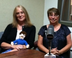 Sturgis Library Director Lucy Loomis with a Kurt Vonnegut doll and Sturgis Library Board member Melanie Lauwers in the CapeCod.Com News Center to talk about the Vonnegut Celebration.