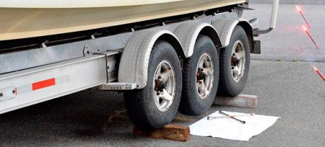 If you have a heavy boat and a trailer with two or more axles, you may find that most portable jacks won’t get the job done for you. A cheap and easy solution is to chock the working tires with 4x6s to hang the one that needs to be changed.