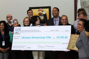 CCB MEDIA PHOTO Members of the Mashpee Wampanoag Tribe, including Tribal Council Chairman Cedric Cromwell, center, and vice chairwoman Jessie "Little Doe" Baird, at right, as well as, at left, Mashpee Wampanoag Powwow Princess Sassamin Weeden, Cape Light Compact Administrator Maggie Downey, and chairwoman of the Cape Light Compact governing board Joyce Flynn display the check recognizing the energy efficiency of the tribe headquarters.