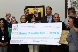 CCB MEDIA PHOTO Members of the Mashpee Wampanoag Tribe, including Tribal Council Chairman Cedric Cromwell, center, and vice chairwoman Jessie "Little Doe" Baird, at right, as well as, at left, Mashpee Wampanoag Powwow Princess Sassamin Weeden,  Cape Light Compact Administrator Maggie Downey, and chairwoman of the Cape Light Compact governing board Joyce Flynn display the check recognizing the energy efficiency of the tribe headquarters.