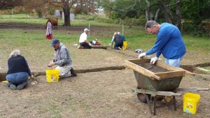 James Kyrimes, right, sifts through soil as volunteers work at the dig on Wednesday.