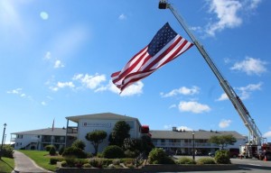 CCB MEDIA PHOTO A giant flag flies over Red Jacket Resort in Yarmouth to welcome the 54 veterans participating in the Wounded Warrior Project on Cape Cod this week.
