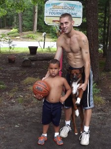 Jonathan Way with his son, Nate, and his dog, Rescue. His dog was with him jogging when he was shot Monday afternoon by a hunter mistaking him for a deer.